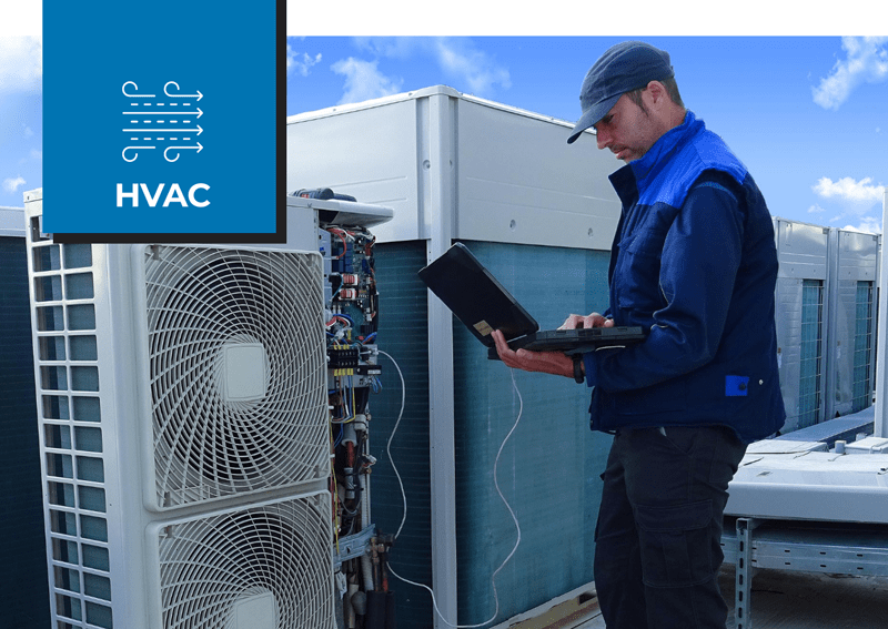 yadon technician servicing rooftop air conditioner with laptop mechanical