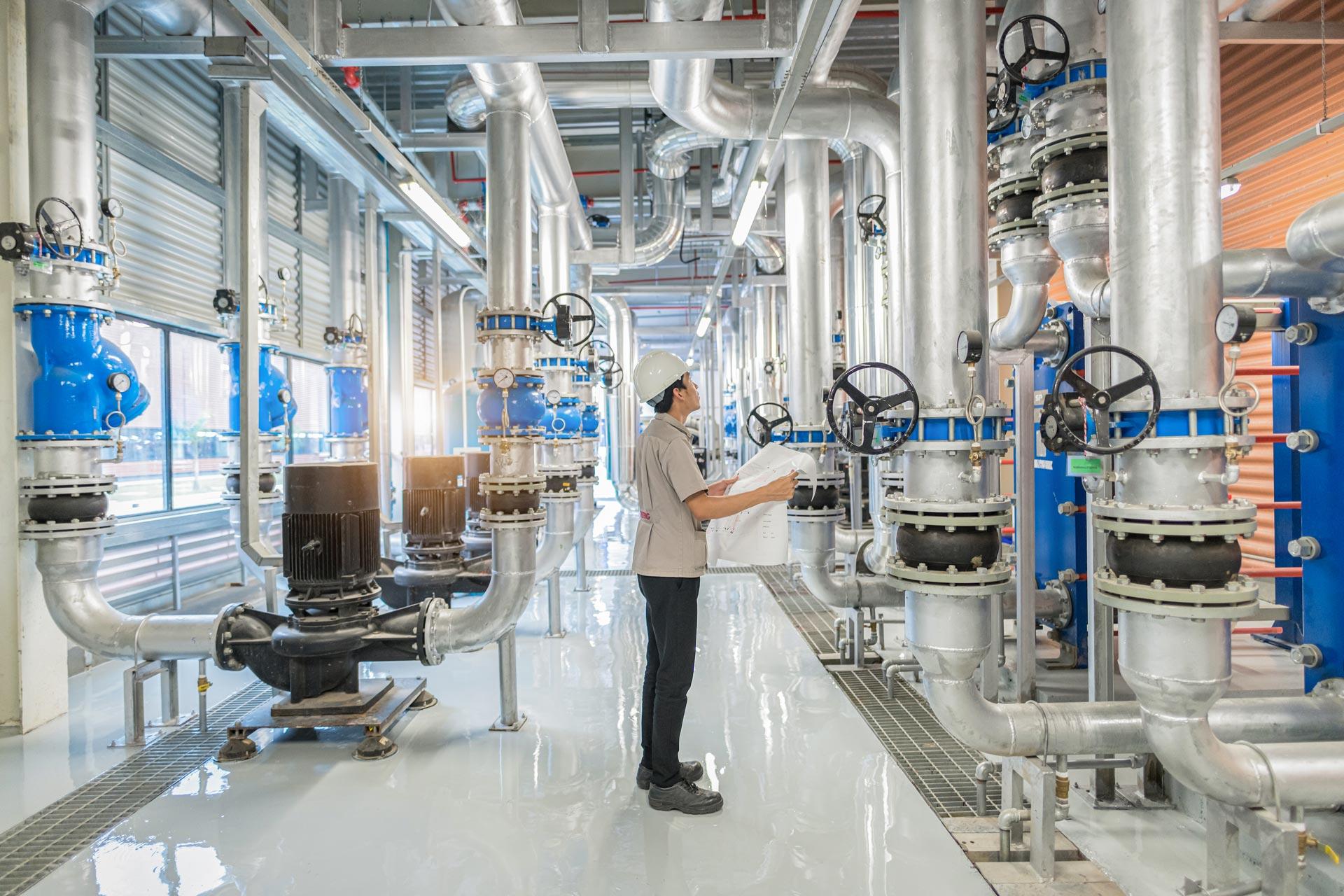 Yadon technician checking building plans and HVAC equipment