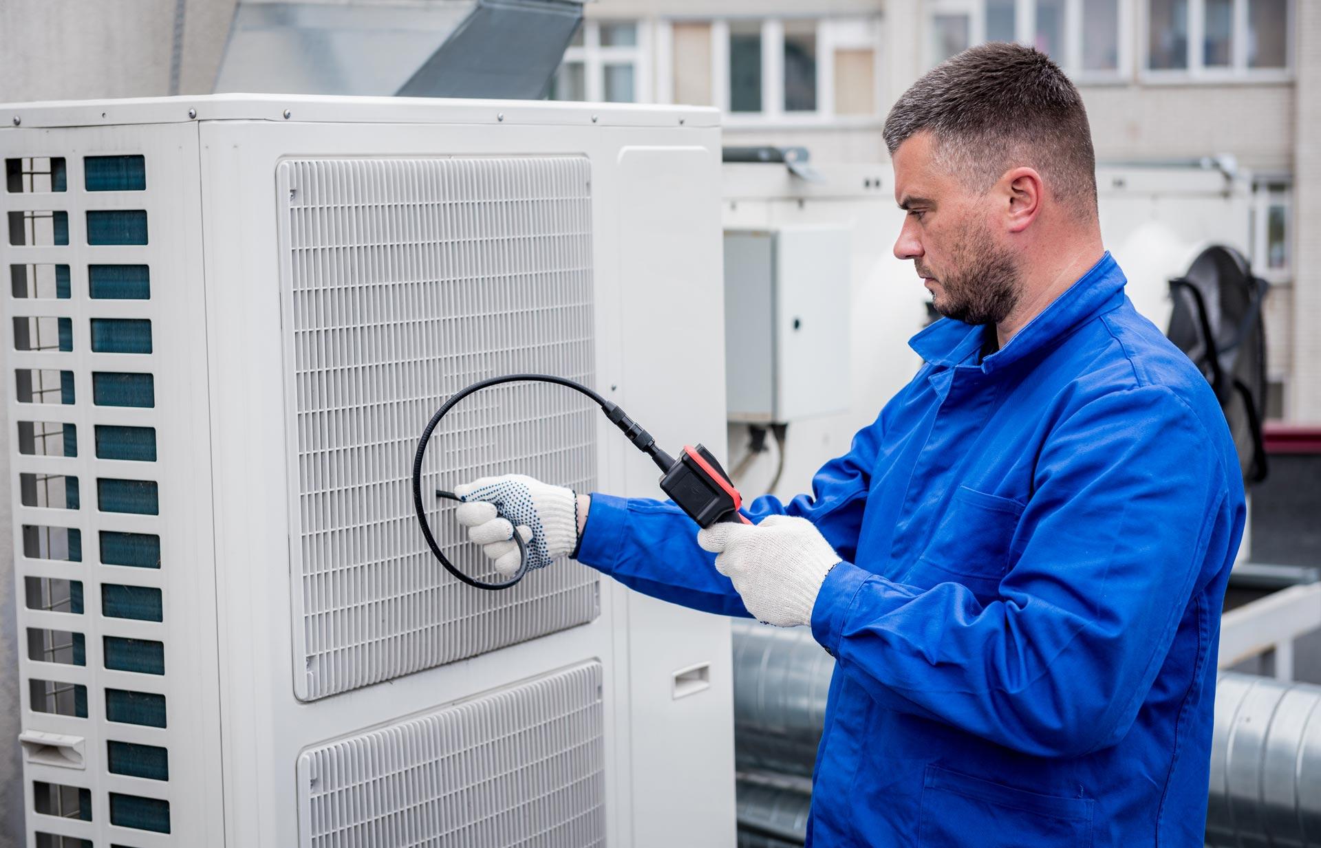 yadon technician testing refrigerant levels in hvac unit